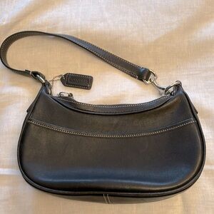 Mini black leather Coach short handled bag with contrast stitching